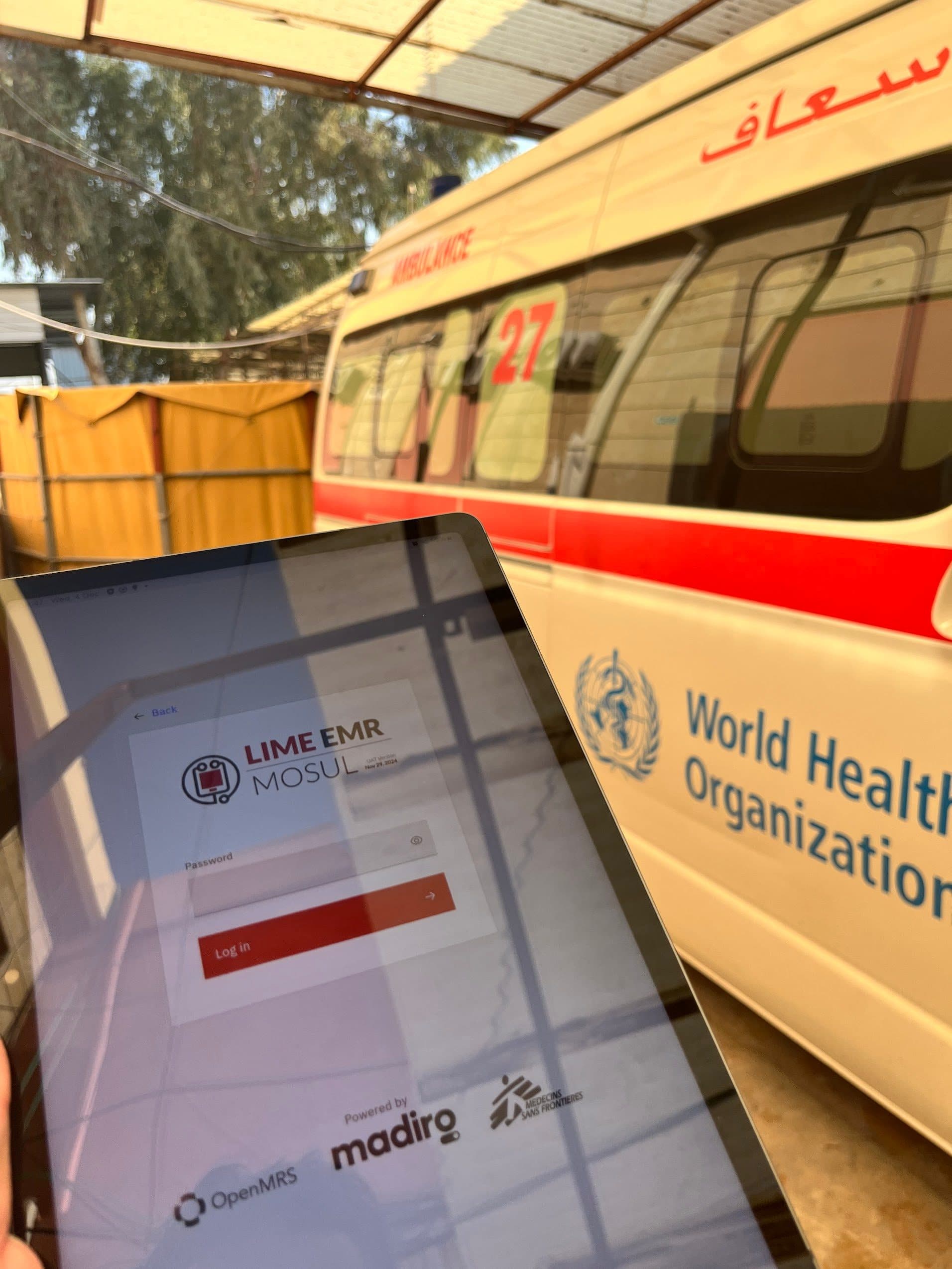 Field health worker using LIME EMR on tablet — MSF deployment, DRC